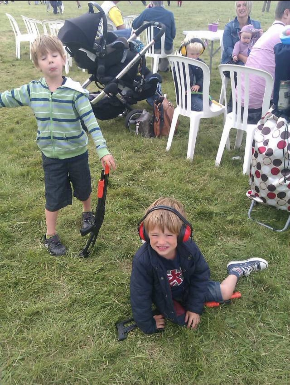 Sam and Alex as young children sitting on grass