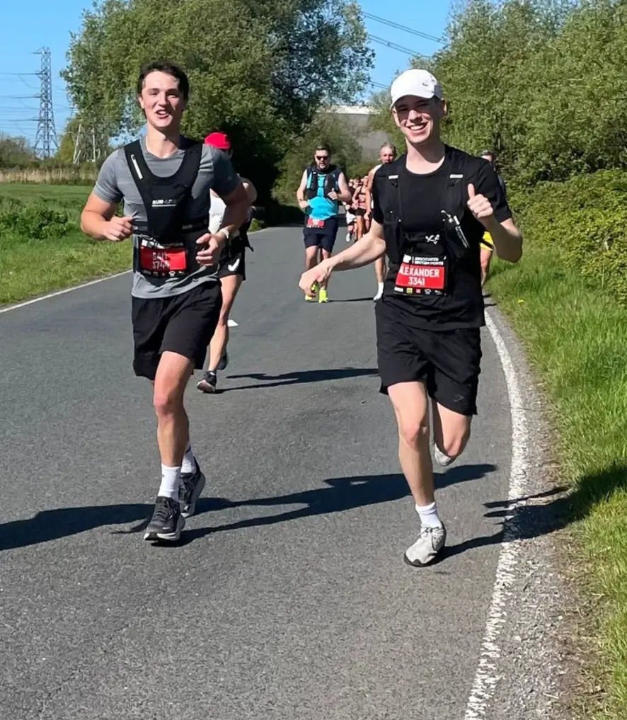 Sam and Alex running a city marathon together